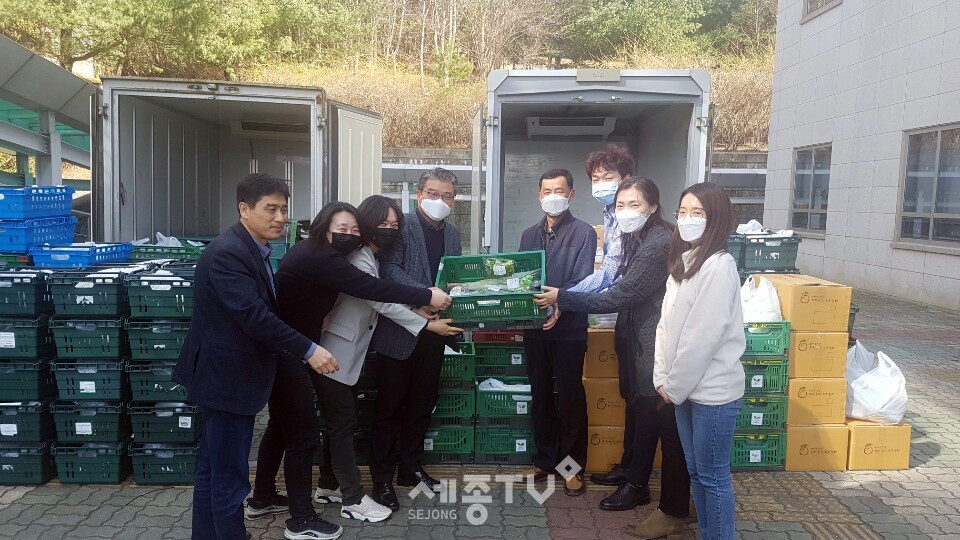 천안시가 친환경 농산물 생산농가 돕는 ‘착한 소비’에 앞장서고 있는 가운데 천안시 공무원들이 공동구매한 친환경농산물꾸러미를 들고 기념촬영을 하고 있다.(사진제공=천안시청)