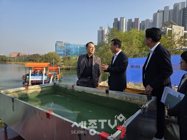 박상돈 천안시장이 성성호수공원에 방문해 육상용 복합공정의 대규모 녹조제거장치에 대한 설명을 듣고 있다.